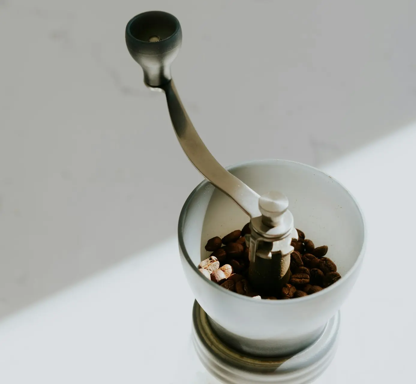 a spoon in a cup filled with cereal and nuts