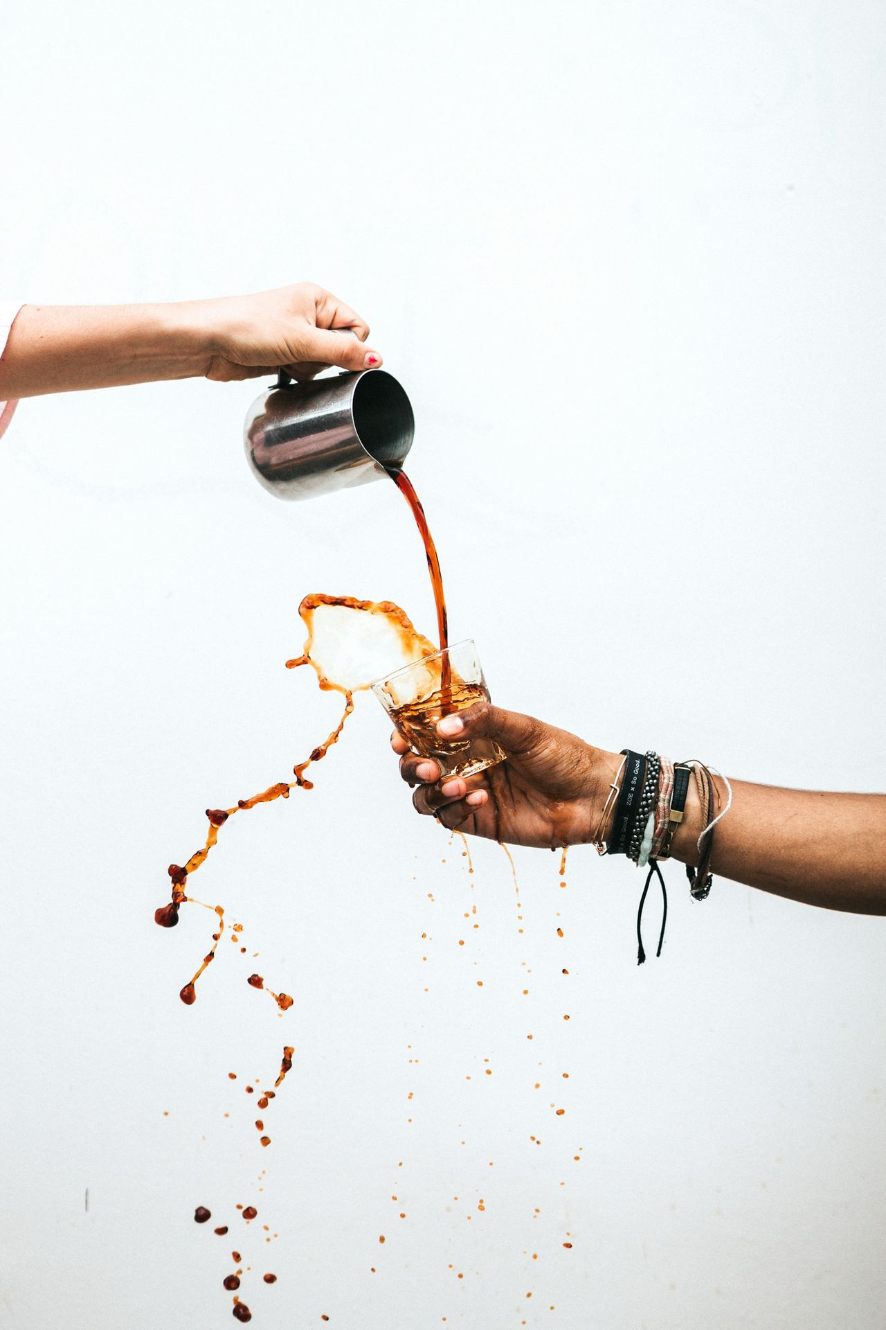 person pouring coffee into glass